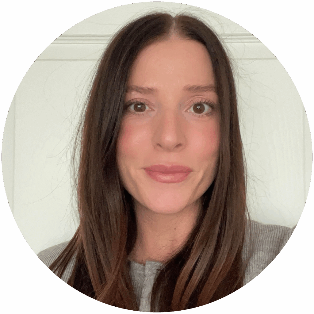 Photo of Kassies Wilson. Kassie has long straight light brown hair, light skin, and is wearing a grey shirt.